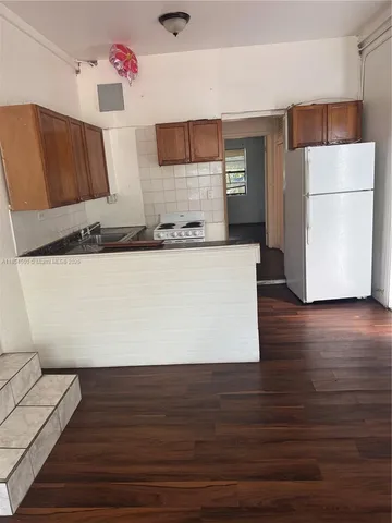 a room with wooden floor and cabinets