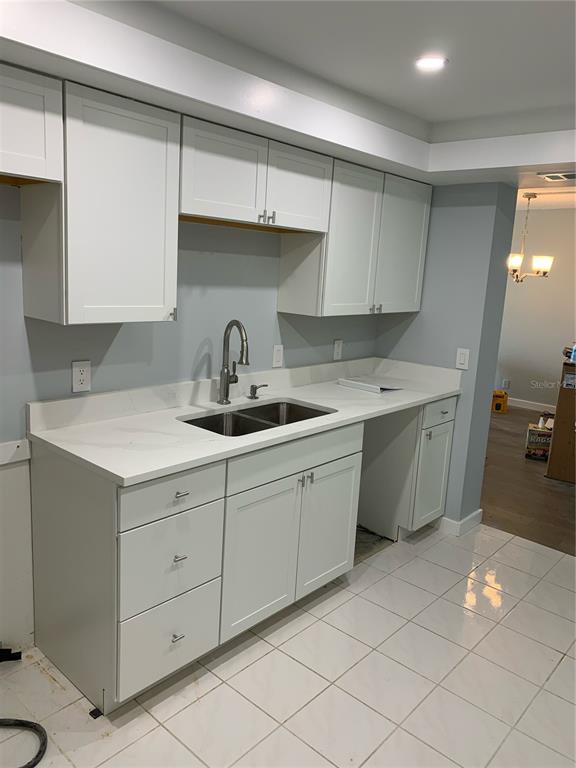 255 Dolphin Point, Unit 809 Clearwater, FL 33767 - Photo 3 of 16 a kitchen with a sink cabinets and utility