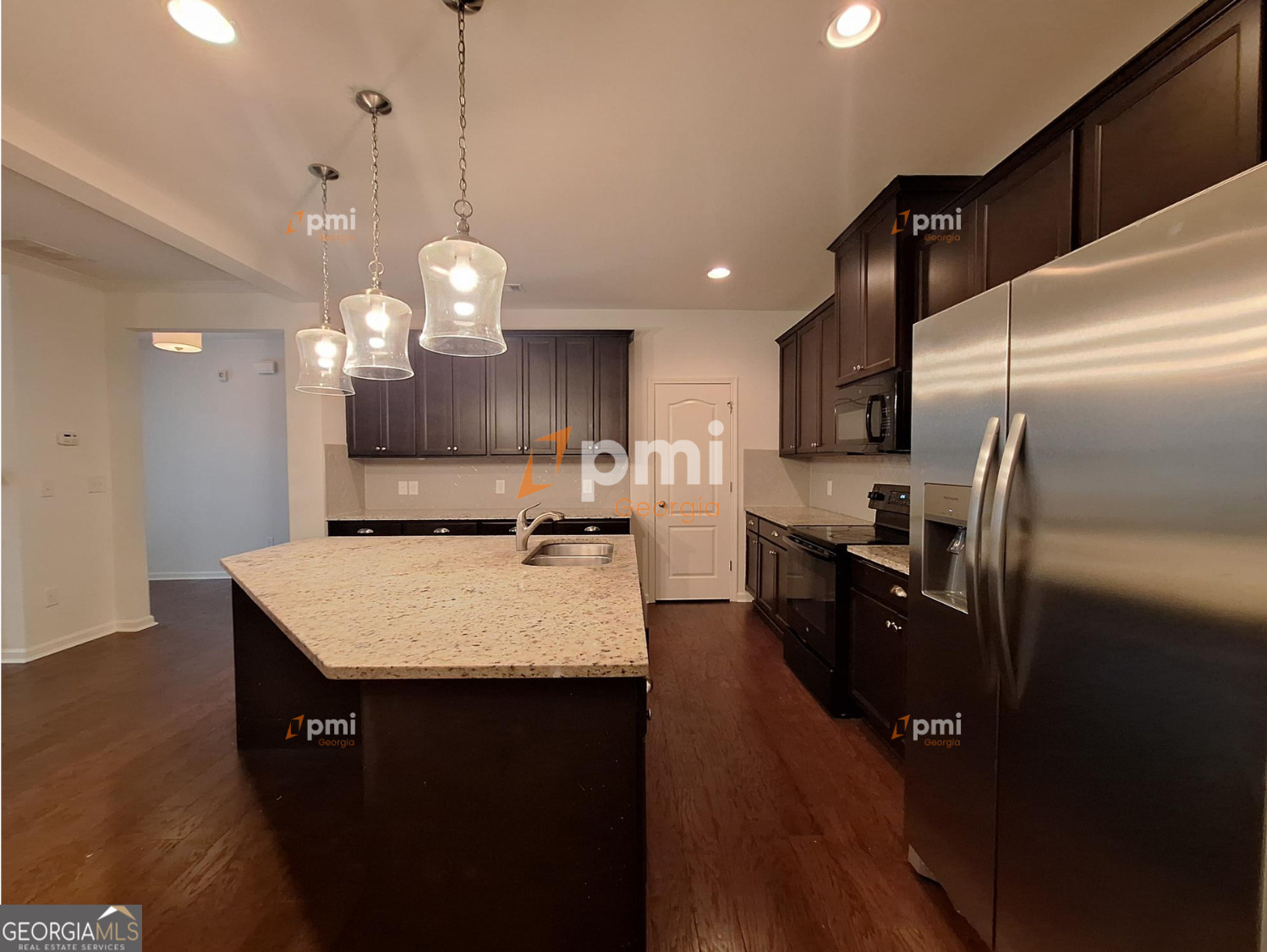 7598 Bucknell Terrace Fairburn, GA 30213 - Photo 3 of 19 a large kitchen with kitchen island a counter space a sink appliances and cabinets