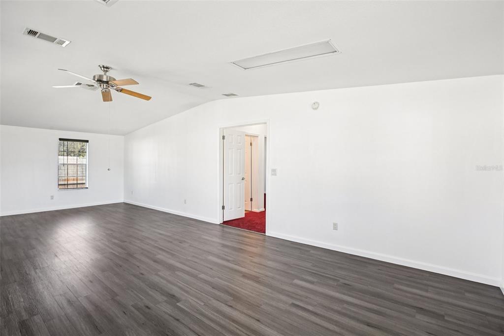 12373 Tree Street Largo, FL 33773 - Photo 16 of 43 a view of a room with wooden floors and ceiling fan