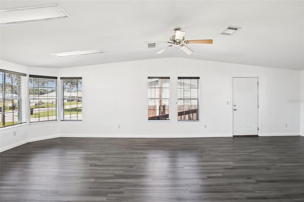 12373 Tree Street Largo, FL 33773 - Photo 17 of 43 a view of an empty room with wooden floor and a window