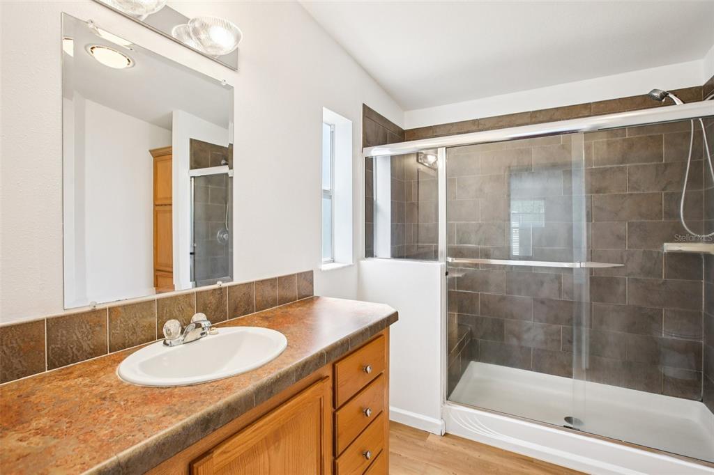 12373 Tree Street Largo, FL 33773 - Photo 24 of 43 a bathroom with a granite countertop sink and a mirror