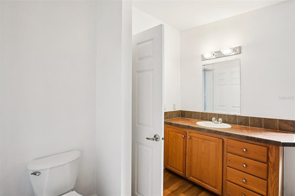 12373 Tree Street Largo, FL 33773 - Photo 25 of 43 a bathroom with a granite countertop sink and a mirror