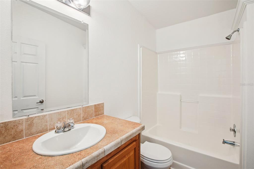 12373 Tree Street Largo, FL 33773 - Photo 28 of 43 a bathroom with a sink toilet and shower