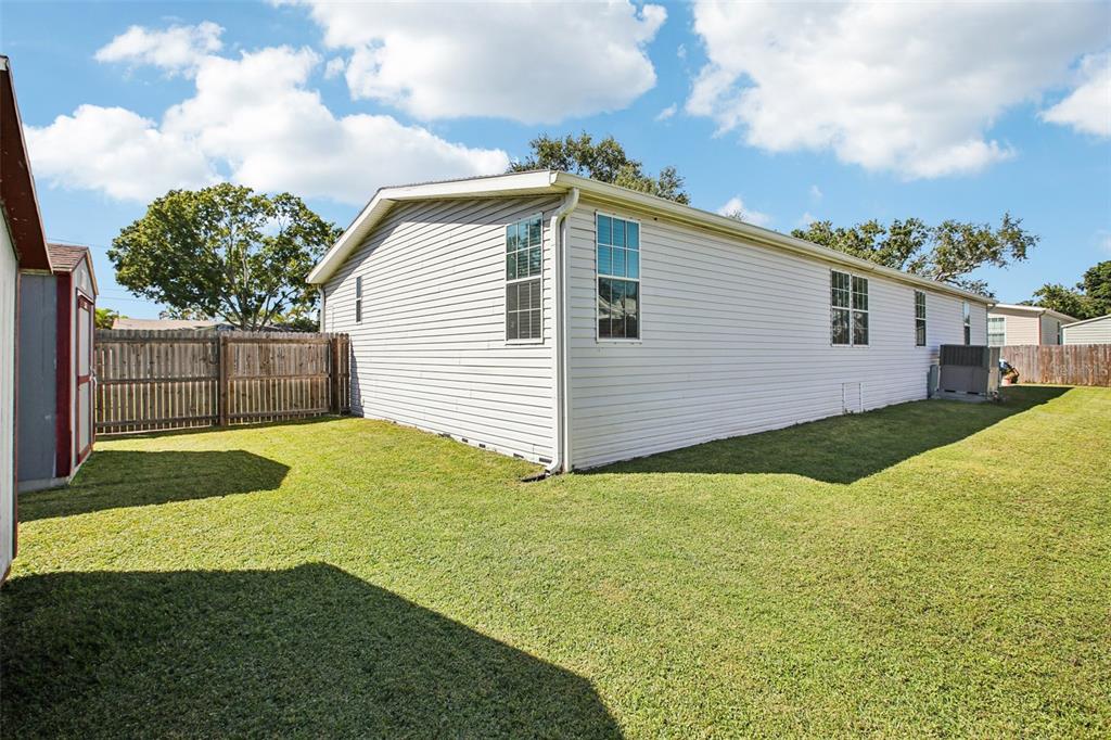 12373 Tree Street Largo, FL 33773 - Photo 35 of 43 a view of backyard of house with green space