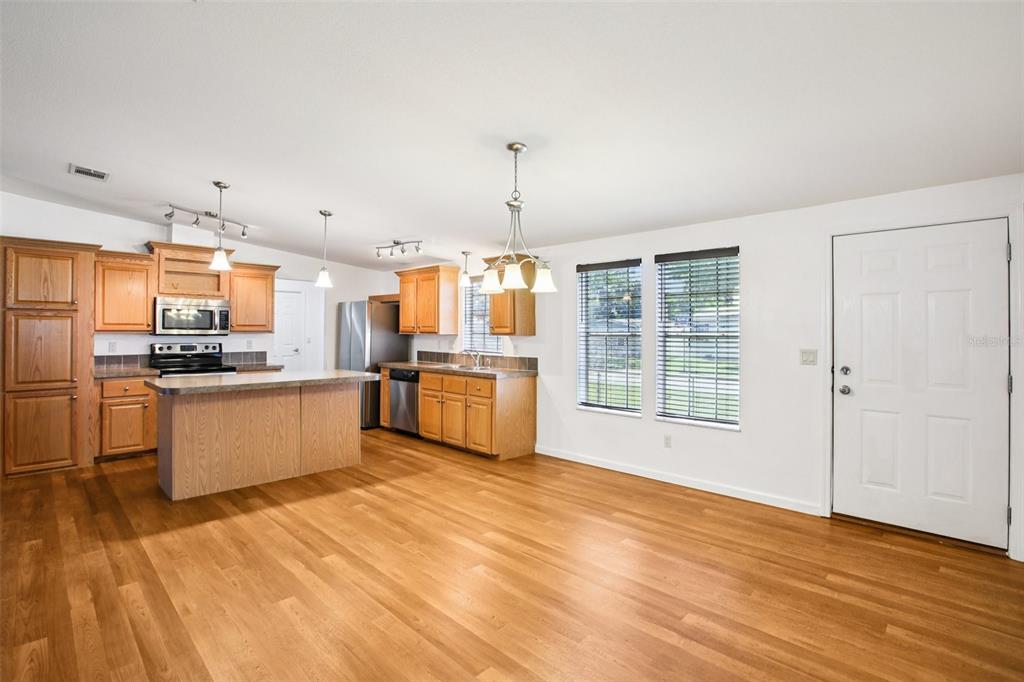 12373 Tree Street Largo, FL 33773 - Photo 7 of 43 a view of kitchen with wooden floor and electronic appliances
