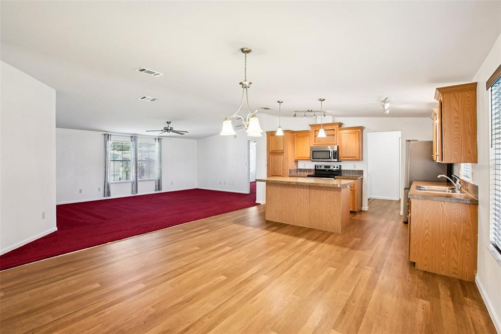 12373 Tree Street Largo, FL 33773 - Photo 8 of 43 a kitchen with stainless steel appliances wooden floor and large windows