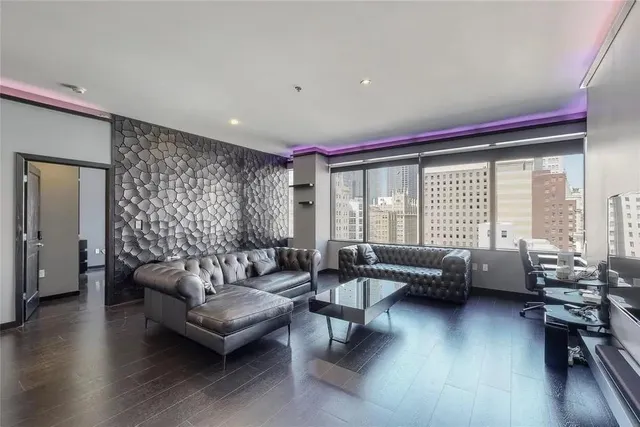 a living room with furniture and a large window