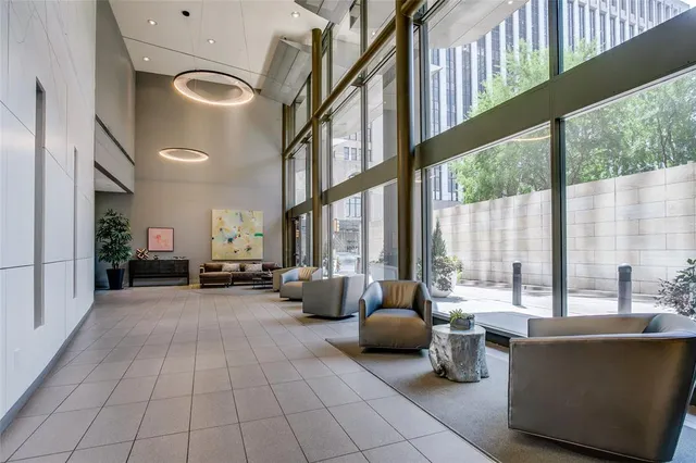 a living room with furniture pool table wooden floor and windows