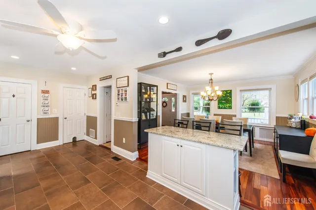 a room with stainless steel appliances lots of counter top space and furniture