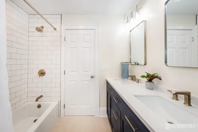 a bathroom with a sink a bath tub and a shower