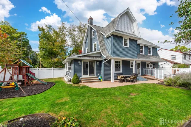 a front view of a house with patio and garden