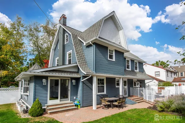 a view of a house with sitting area and garden