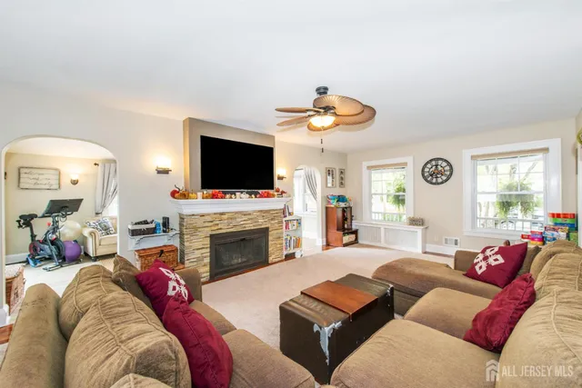a living room with furniture a fireplace and a flat screen tv