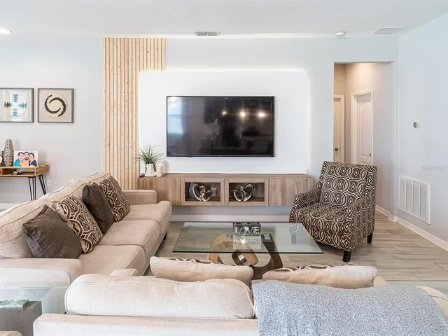 a living room with furniture and a flat screen tv