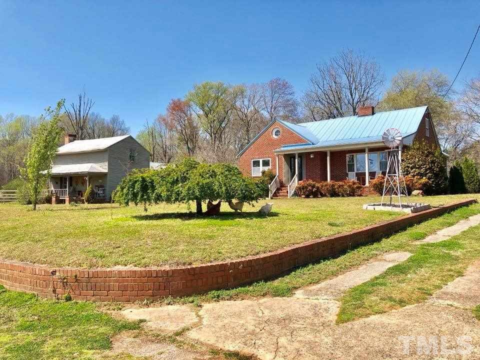 41 Anderson Jones Road Roxboro, NC 27574 - Photo 1 of 25 a front view of a house with a yard table and chairs