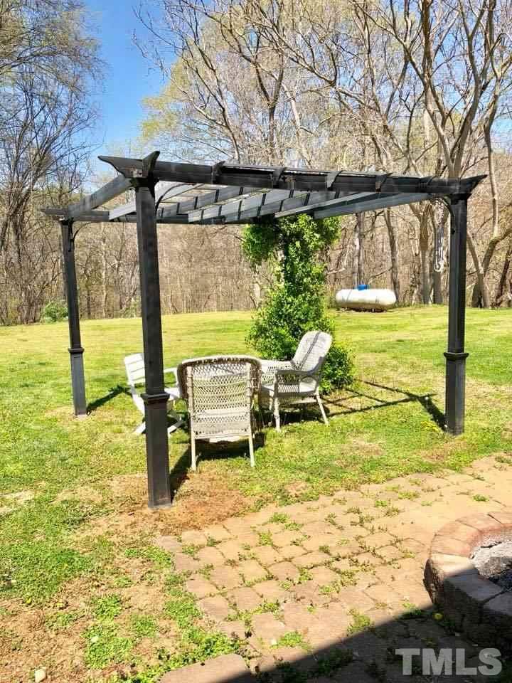41 Anderson Jones Road Roxboro, NC 27574 - Photo 25 of 25 a swimming pool with lawn chairs and wooden fence