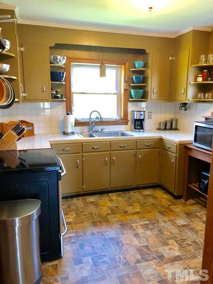 41 Anderson Jones Road Roxboro, NC 27574 - Photo 8 of 25 a kitchen with a sink cabinets and window