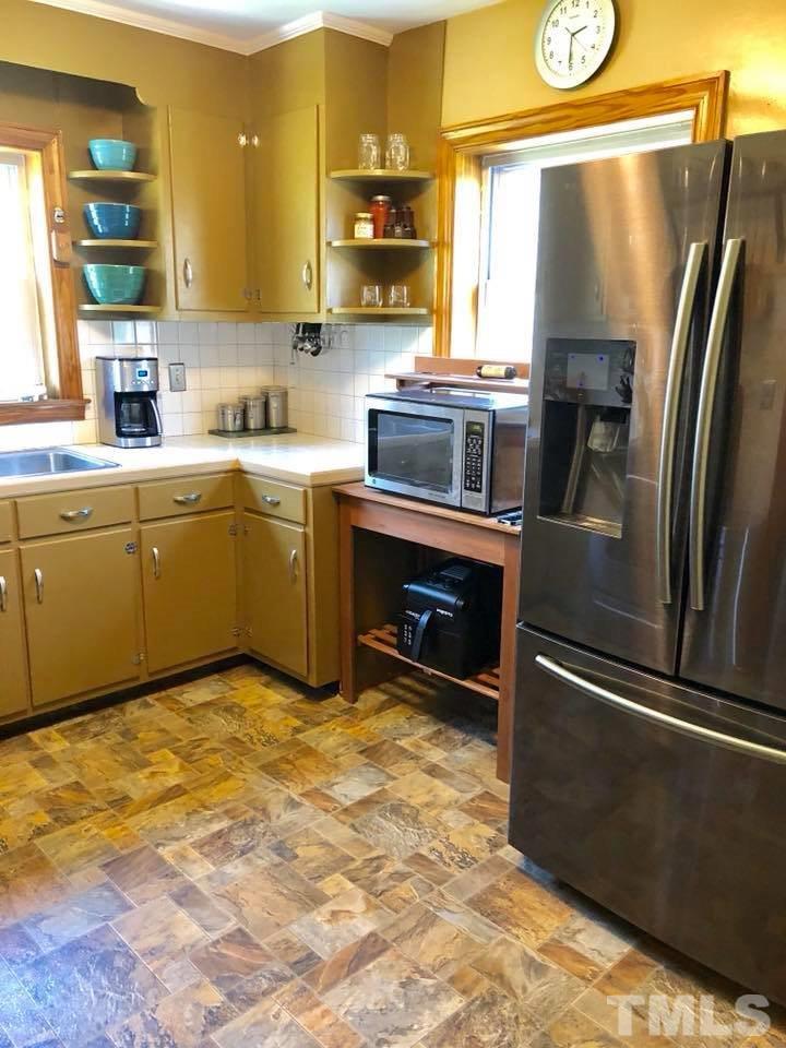 41 Anderson Jones Road Roxboro, NC 27574 - Photo 9 of 25 a kitchen with granite countertop a refrigerator stove and sink