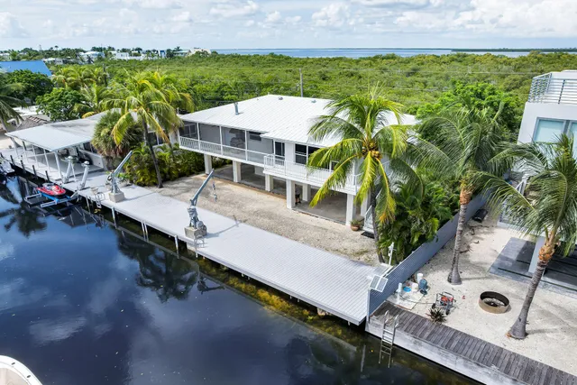 an aerial view of a house with swimming pool and garden