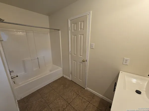 a bathroom with a tub and shower