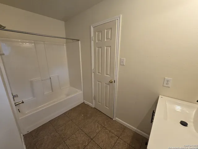 a bathroom with a tub and shower