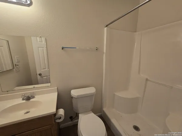 a bathroom with a sink toilet and shower