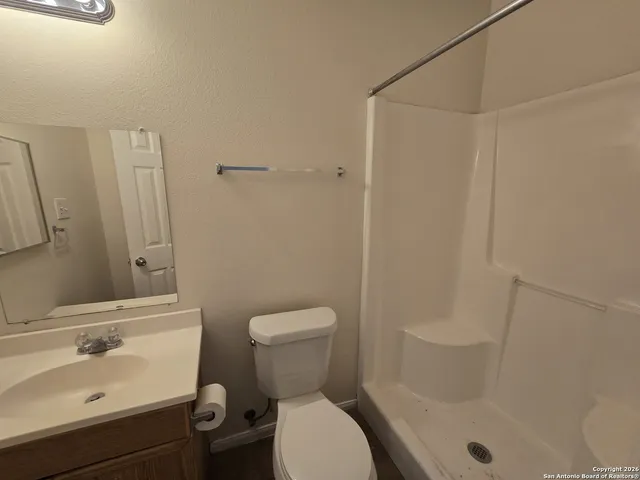 a bathroom with a sink toilet and shower