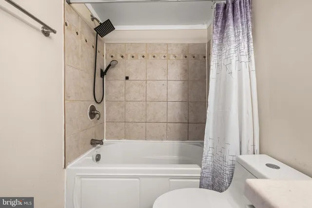 a bathroom with a shower a toilet and a shower