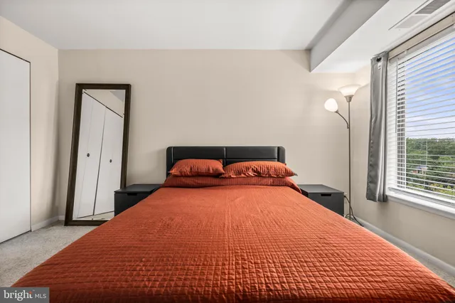 a bedroom with a bed and window