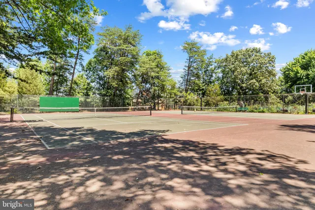 a view of a wooden deck with a table and chairs under an umbrella