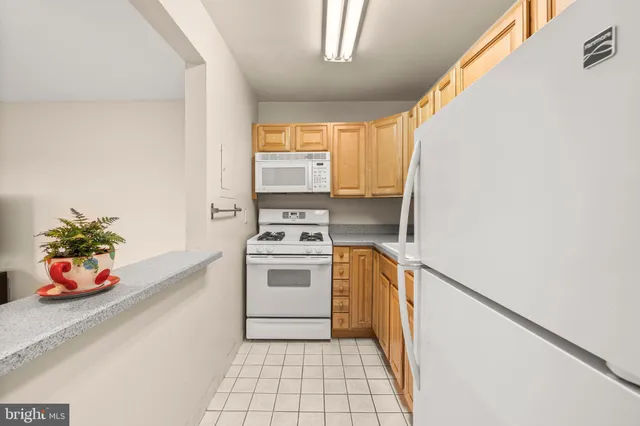 a kitchen with a refrigerator and a stove