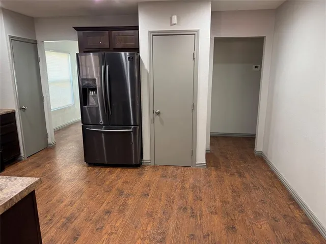 a view of a refrigerator in kitchen and wooden floor