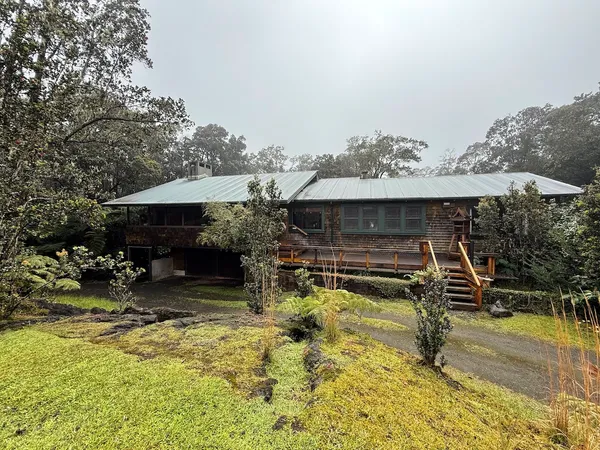 a view of a house with swimming pool and sitting area