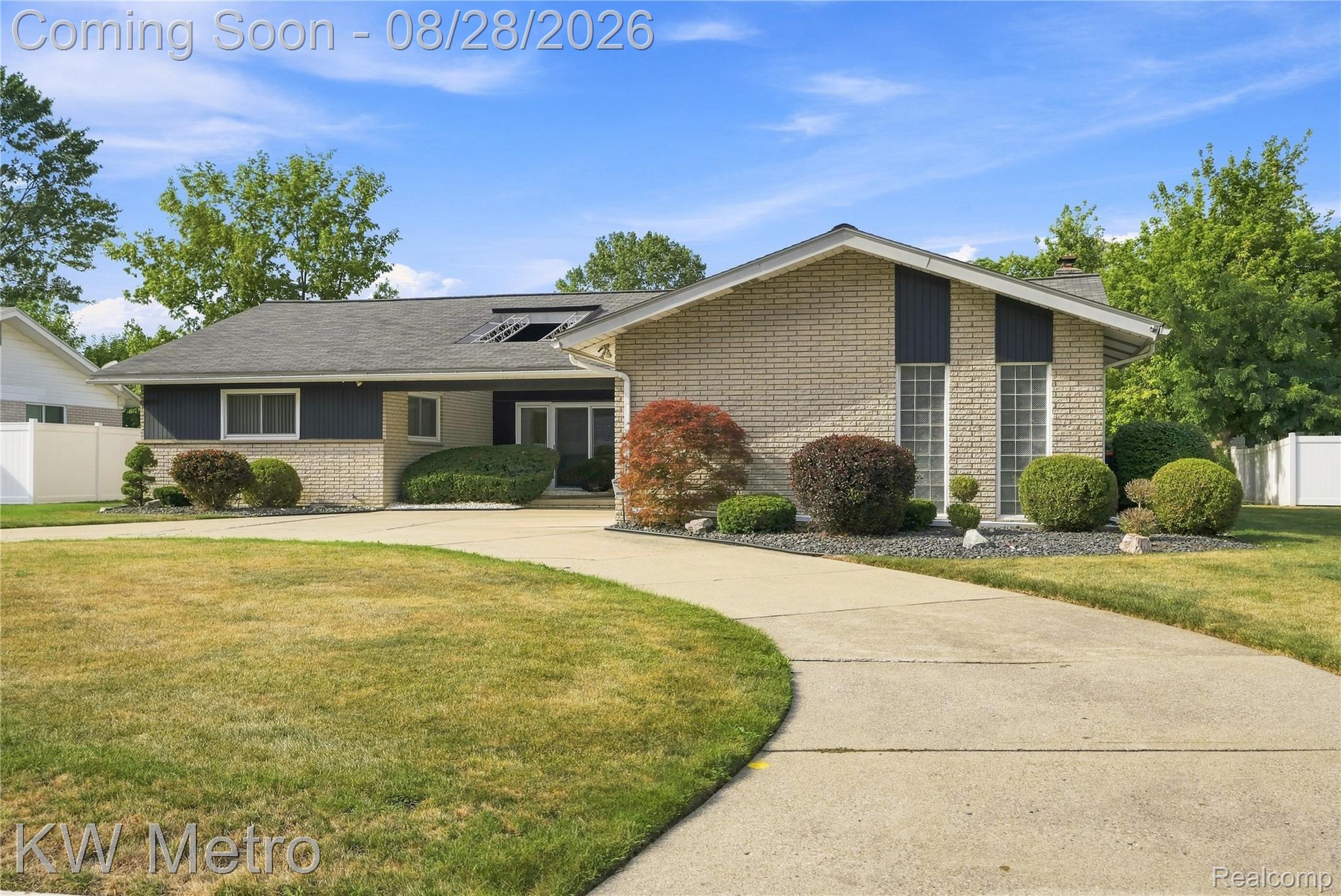17700 Adrian Road Southfield, MI 48075 - Photo 1 of 24 Brick exterior with dark siding accents, concrete driveway, and mature landscaping