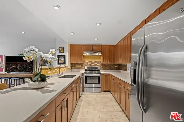 a kitchen with stainless steel appliances granite countertop a sink and stove