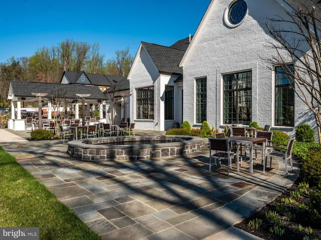 a view of a patio with table and chairs and potted plants