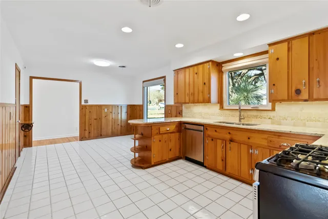 a kitchen with a sink stove top oven and cabinets