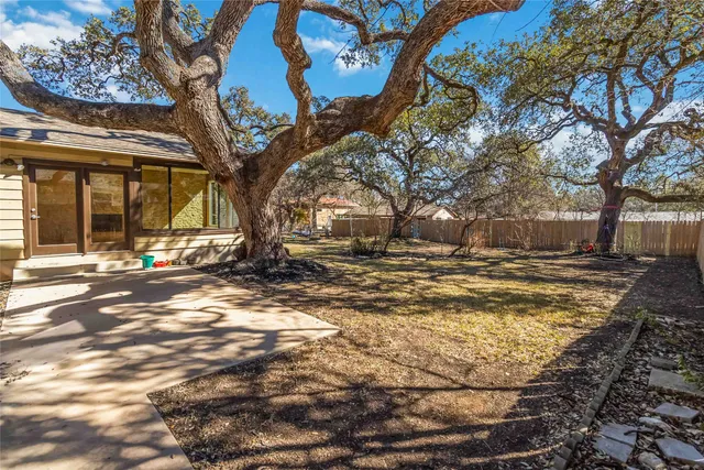 a view of road with large trees