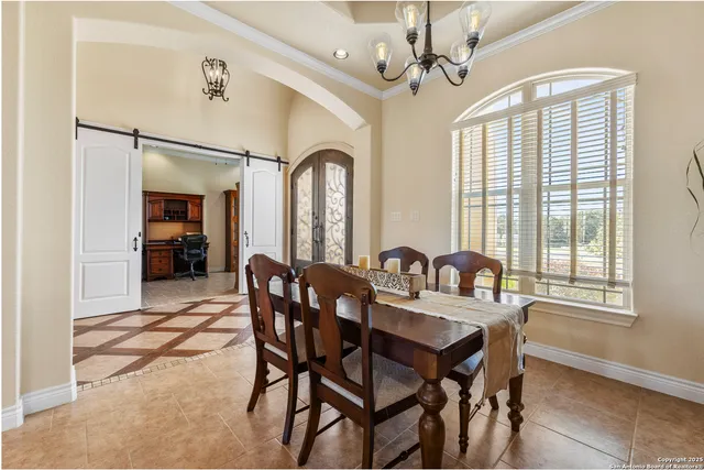 a view of a a dining room with furniture window and wooden floor