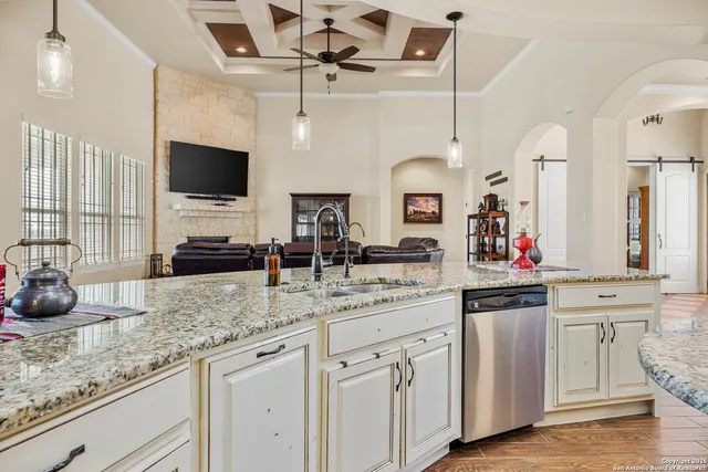 a kitchen with stainless steel appliances granite countertop a sink and a stove