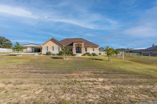 a view of house with outdoor space and swimming pool