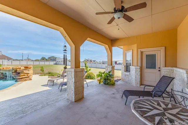 a building outdoor space with patio furniture and a ceiling fan