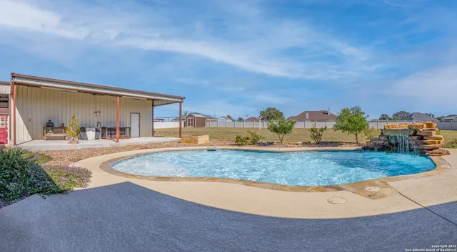 a view of swimming pool with outdoor seating