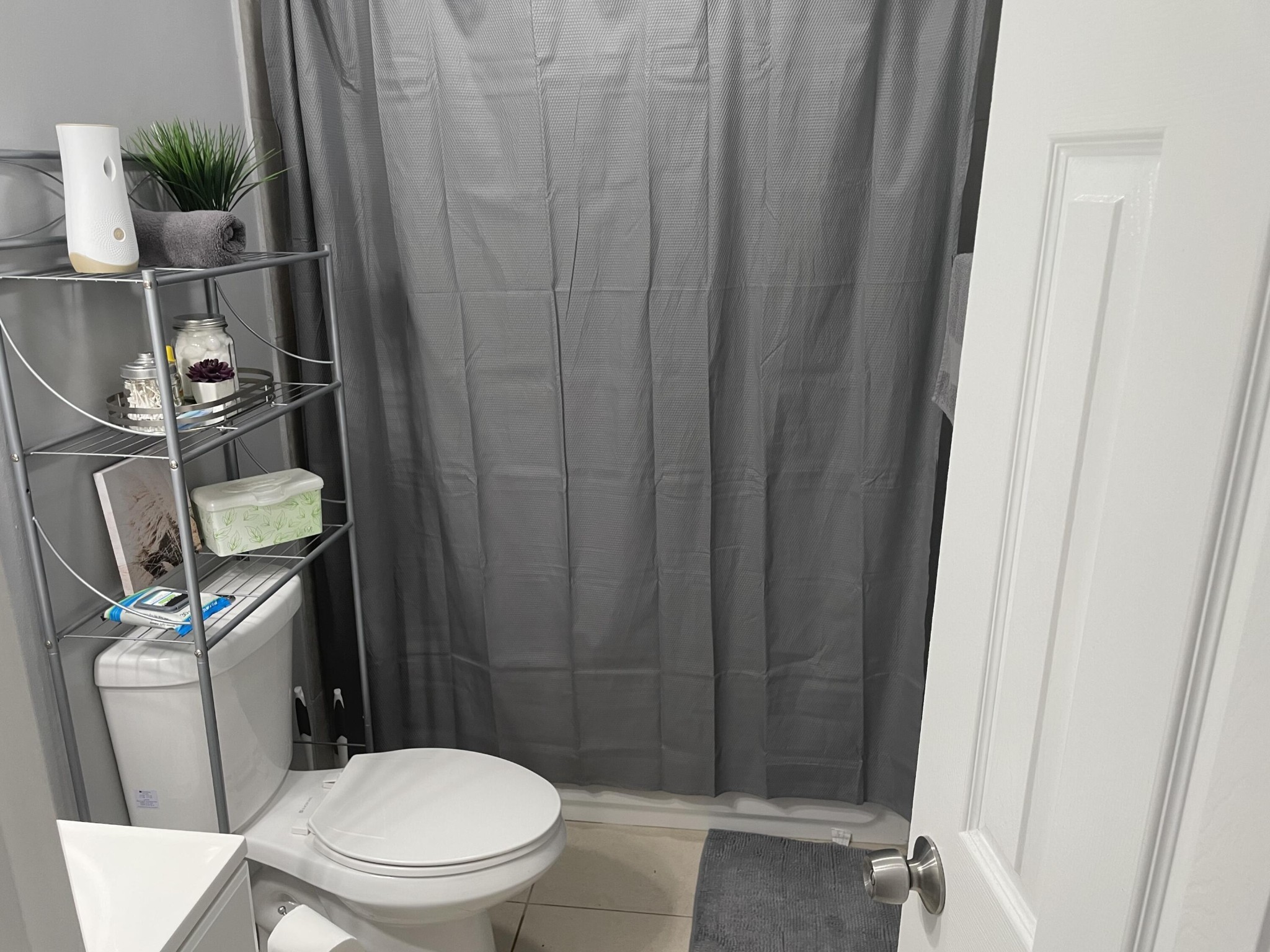 107109 Hunter Place Oak Ridge, TN 37830 - Photo 8 of 9 a white toilet sitting next to a shower curtain