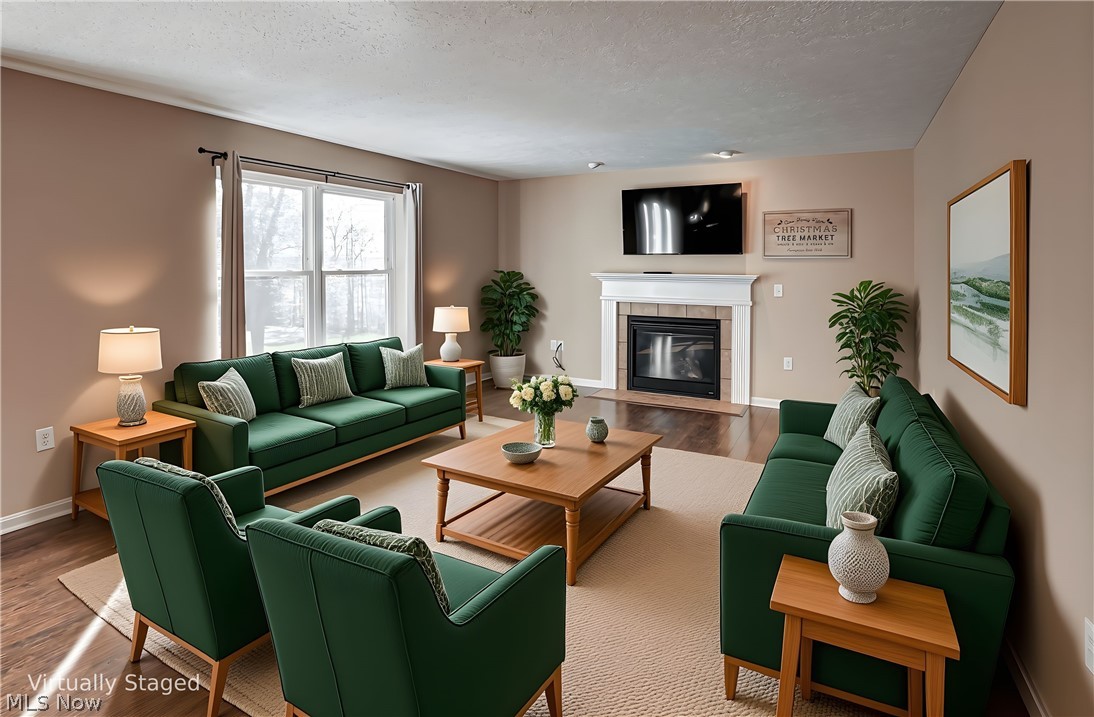 11768 Valley View Road Northfield, OH 44067 - Photo 15 of 45 Living room with wood finished floors, a tiled fireplace, and a textured ceiling