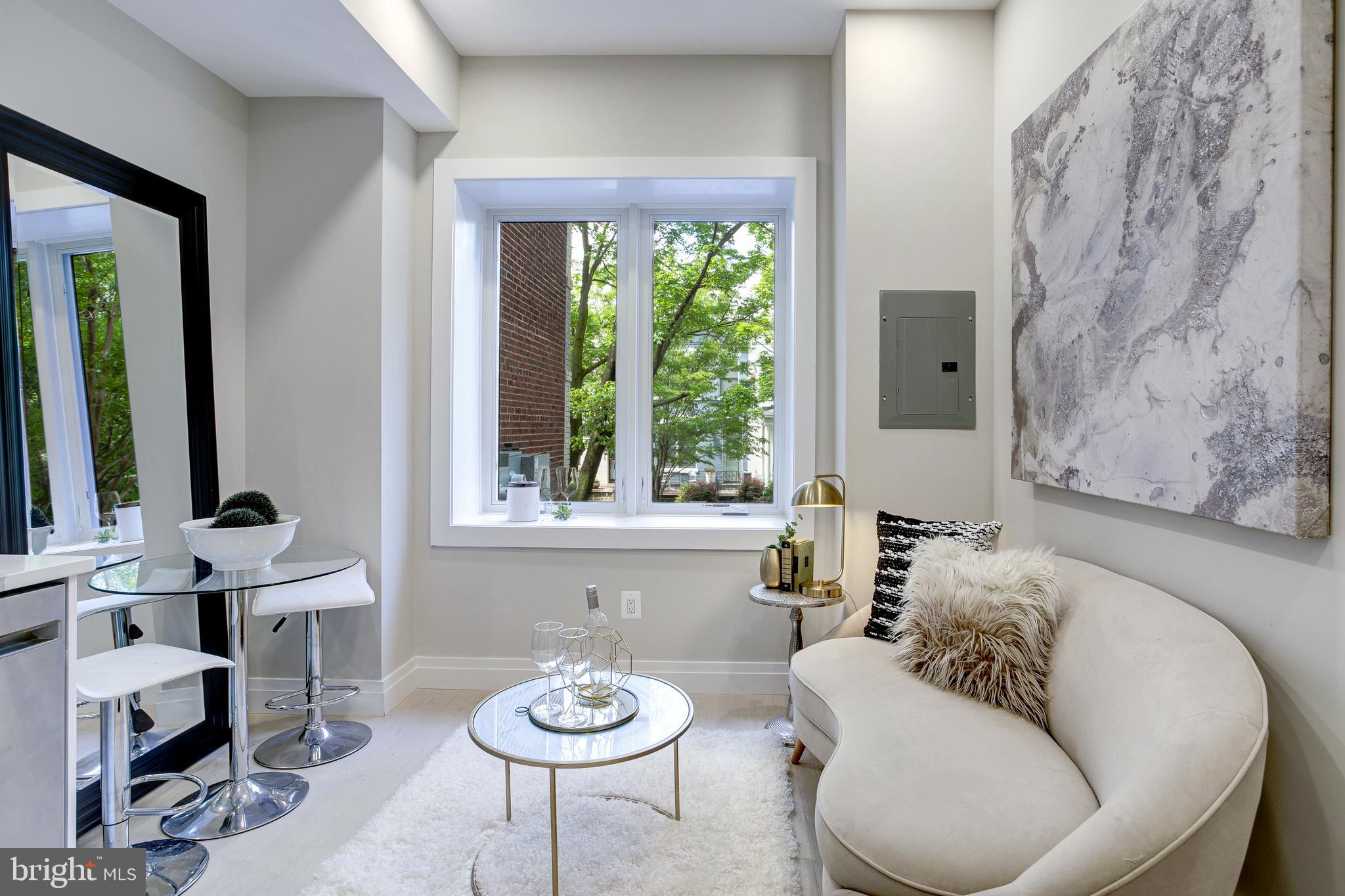 2301 Ontario Road Northwest, Unit 101 Washington, DC 20009 - Photo 11 of 24 a living room with furniture and a window