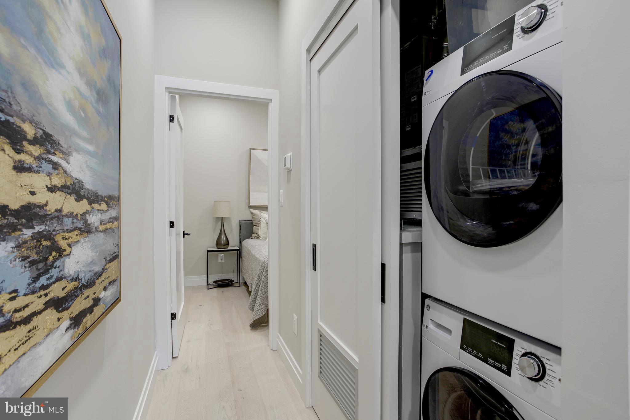 2301 Ontario Road Northwest, Unit 101 Washington, DC 20009 - Photo 13 of 24 a view of a hallway with washer and dryer