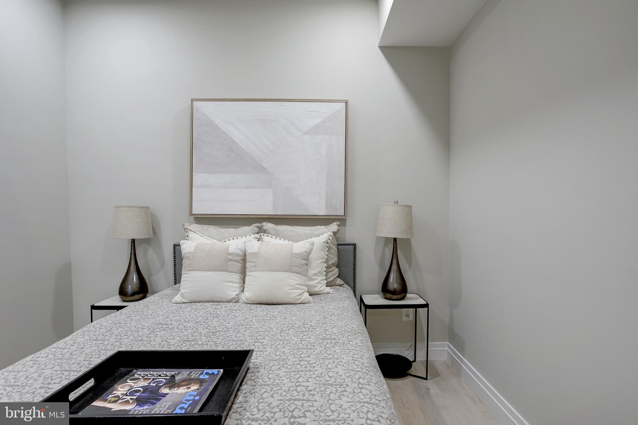 2301 Ontario Road Northwest, Unit 101 Washington, DC 20009 - Photo 17 of 24 a bedroom with a bed and a night stand