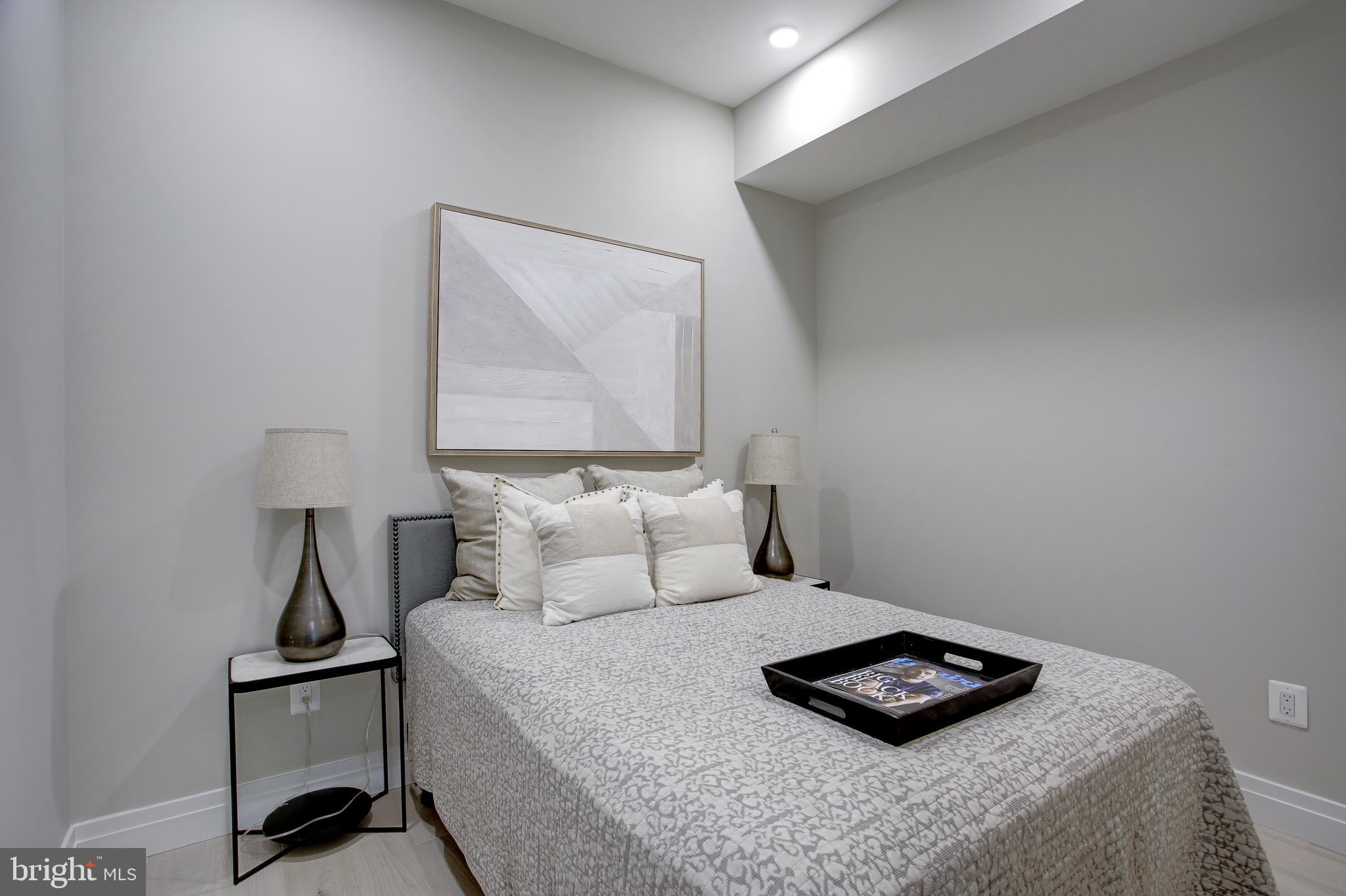 2301 Ontario Road Northwest, Unit 101 Washington, DC 20009 - Photo 18 of 24 a bedroom with a bed and a night stand